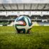 multicolored soccer ball on green field