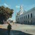 people walking on street sidewalk near museo de arte contemporaneo ateneo in merida mexico